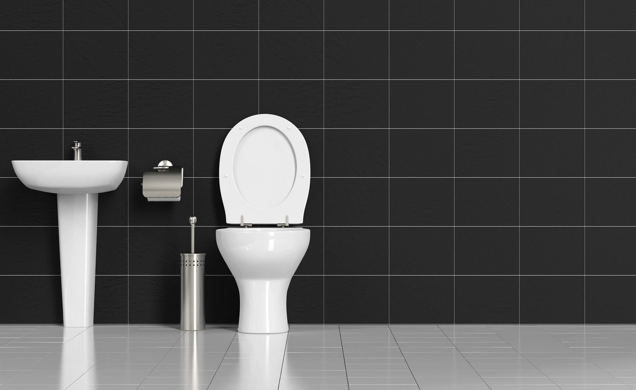 toilet-and-vanity-against-black-tiles